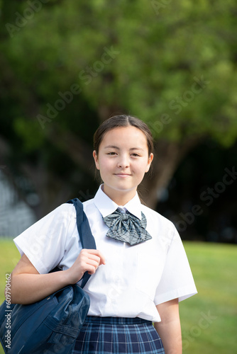 こちらを見ている制服姿の女子学生 photo