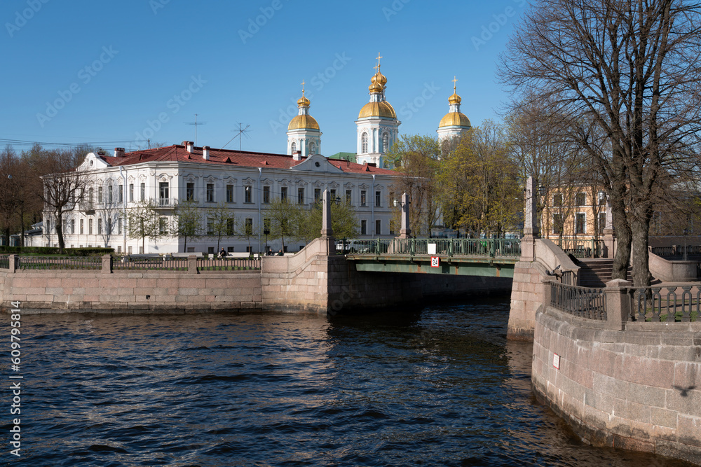 View of the Krasnogvardeysky Bridge over the Griboyedov Canal and the dome of the St. Nicholas Naval Cathedral on a sunny spring day, St. Petersburg, Russia