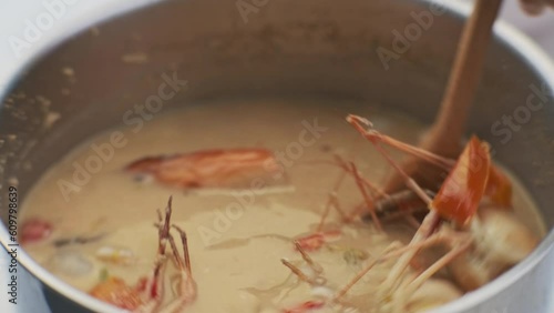 Spicy prawn soup. Traditional Asian tom yam soup with prawns and coconut milk in a pot.