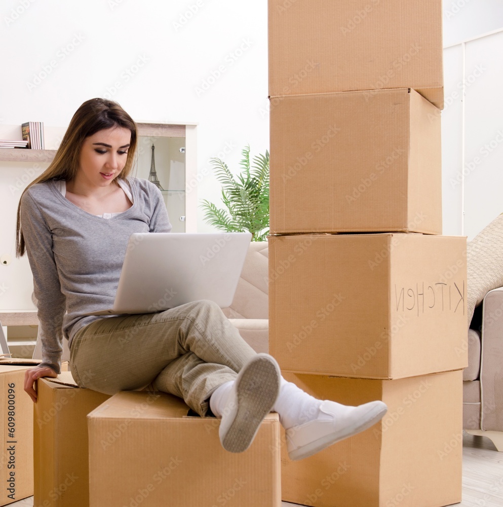 Young beautiful woman moving to new flat Young beautiful woman moving to new flat
