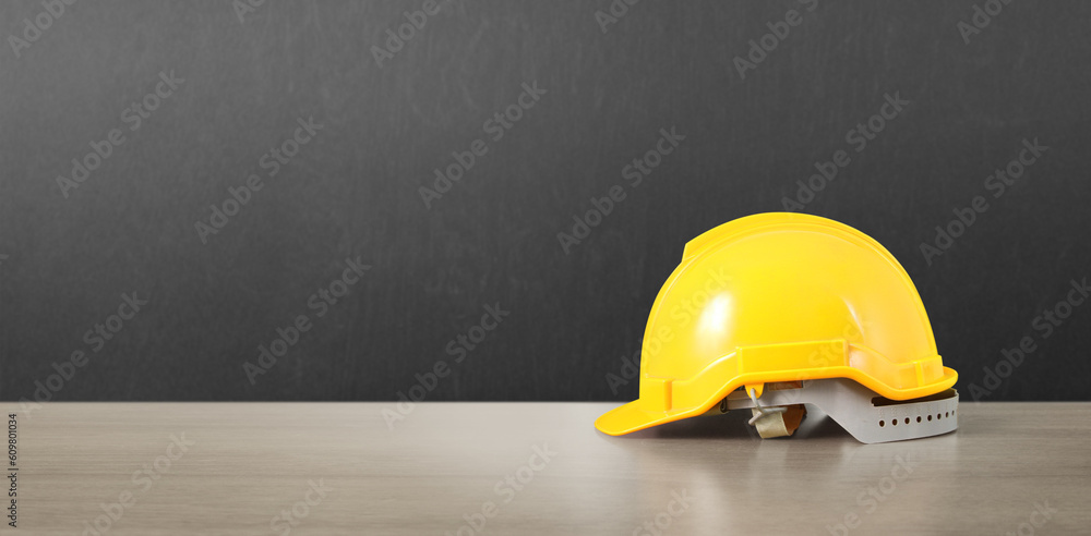 Yellow hardhat model house and coin with trading graph Yellow hardhat model house and coin with trading graph