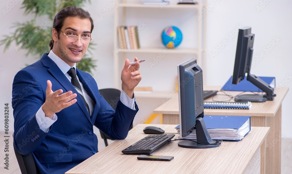 Young male employee working in the office Young male employee working in the office