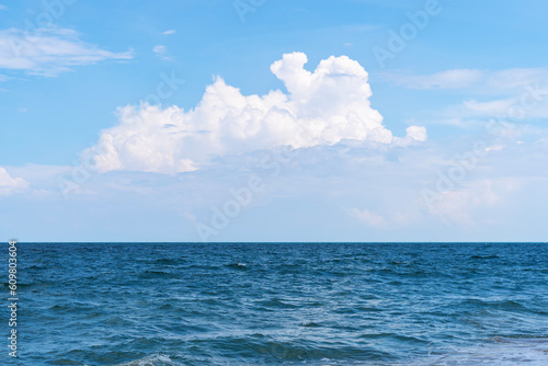 Front view in bright blue morning sky with clear white clouds and deep blue ocean in daytime feel cool calm relax idea for cool background
