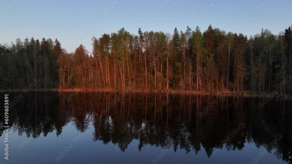 Flight above the calm, smooth Tündre lake during sunset in spring. Estonia. Flight above the calm, smooth Tündre lake during sunset in spring. Estonia.
