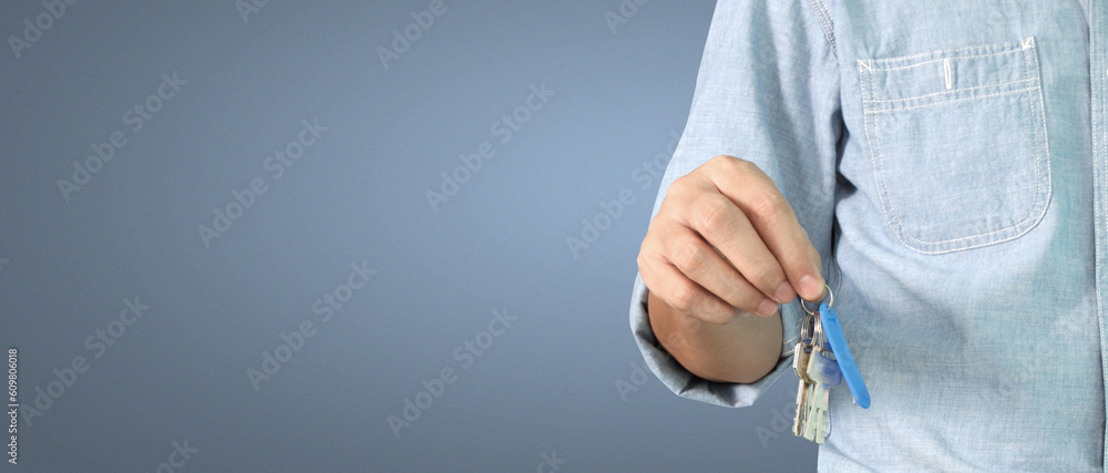 Fototapeta premium Real estate agent handing over house keys in hand