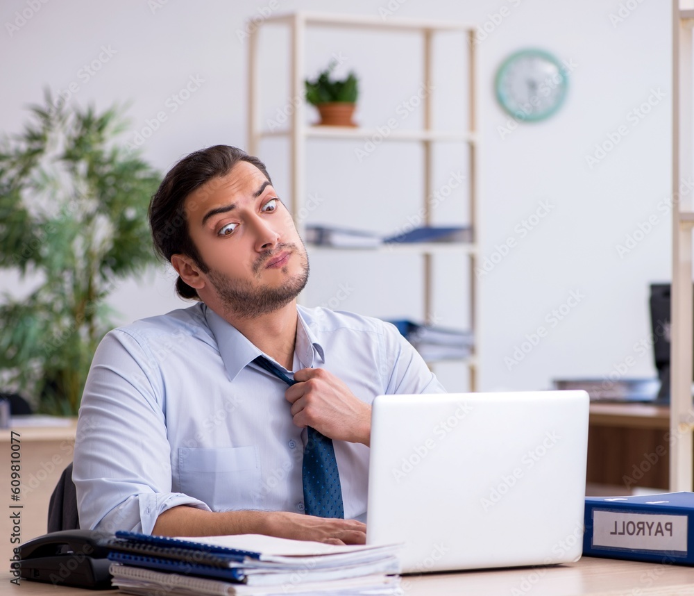 Young male bookkeeper working in the office Young male bookkeeper working in the office