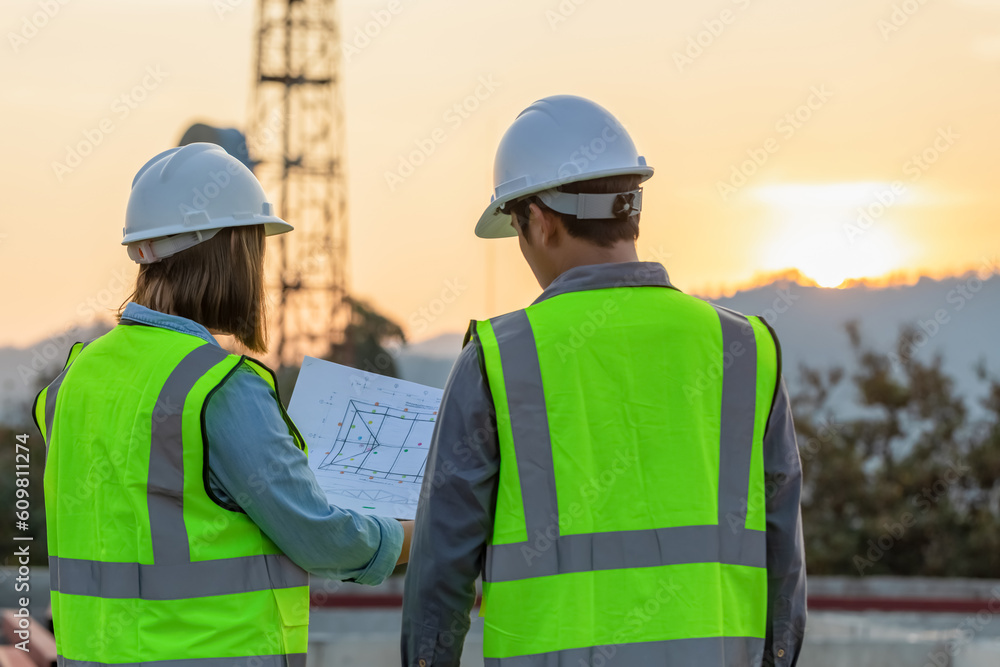 Professional team Engineer managers workers working outdoors with telecommunication antenna and sunset background. Professional team Engineer managers workers working outdoors with telecommunication antenna and sunset background.
