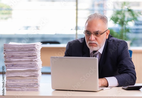 Aged businessman employee unhappy with excessive work