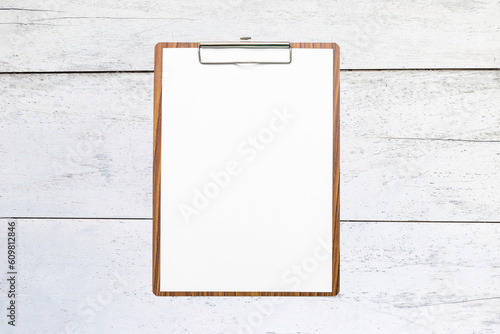 Blank wooden clipboard on old white wooden background, blank white paper on wooden clipboard