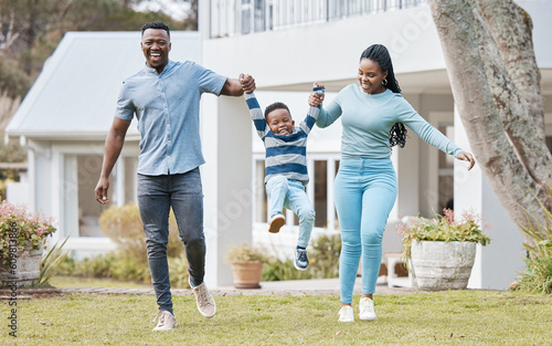 Happy parents lifting their kid by their new home in the outdoor garden while playing together. Backyard, bonding and African mother and father holding their boy child in the backyard of their house.