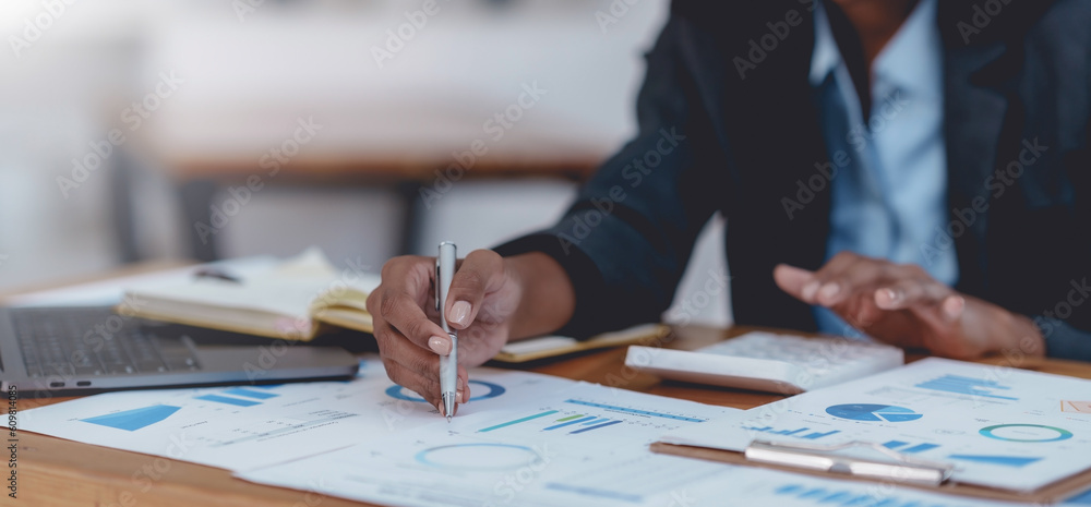 Close-up of businesswoman hands using a calculator to check company finances and earnings and budget. Business woman calculating monthly expenses, managing budget, papers, loan documents, invoices. Close-up of businesswoman hands using a calculator to check company finances and earnings and budget. Business woman calculating monthly expenses, managing budget, papers, loan documents, invoices.