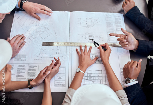 Teamwork, architecture and blueprint with people in meeting for graphic, engineering and planning from above. Floor plans, documents and construction with designers for illustration and development