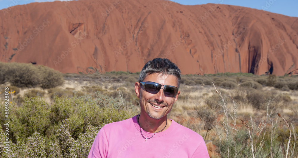 Portrait of a happy caucasian man hiking along the australian outback on a beautiful sunny day
