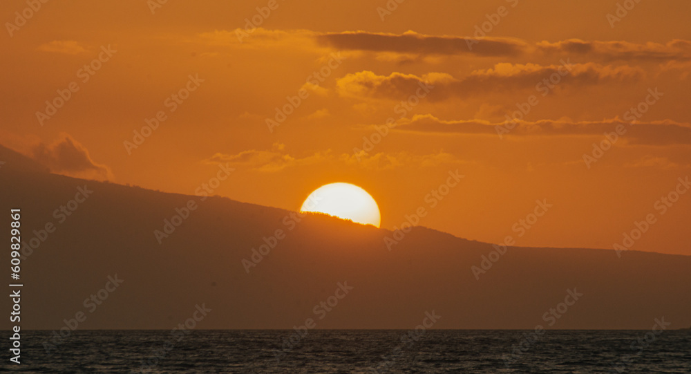 Magical golden sunset from Maui beach, sea and mountain background. 