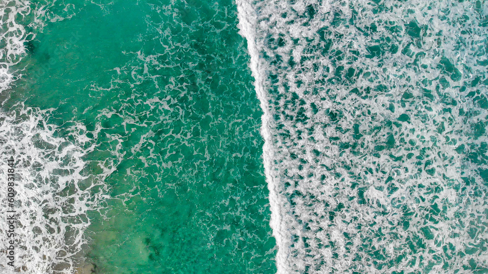 Above the ocean, aerial view at the waves and surface near shoreline - Drone viewpoint Above the ocean, aerial view at the waves and surface near shoreline - Drone viewpoint