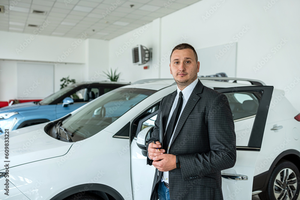 smile salesman or client alone at new car showroom smile salesman or client alone at new car showroom
