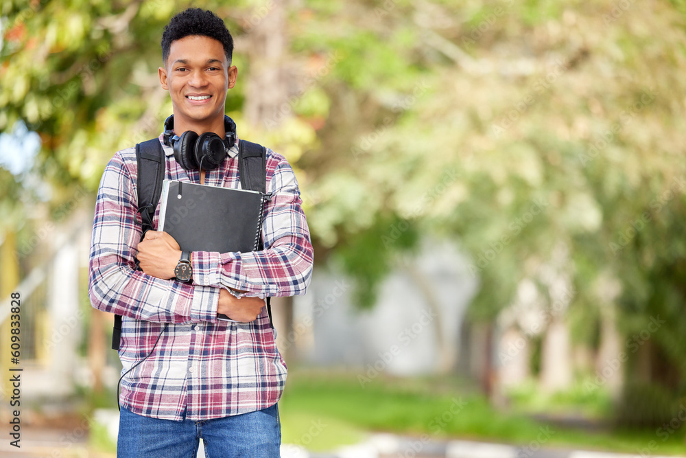 Happy, ready and portrait of a man on campus for education, learning and knowledge with mockup space. Smile, university and a young male student with books in a college park to start studying