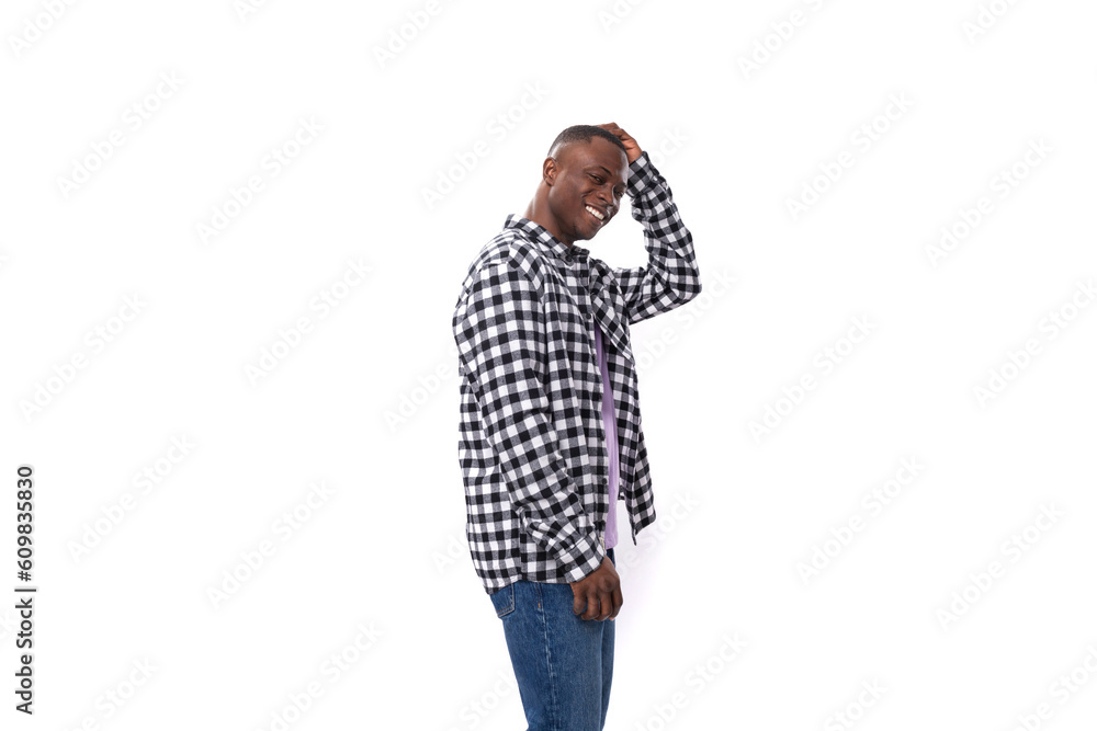 30 year old African guy dressed in a plaid black and white shirt posing on an isolated background with copy space 30 year old African guy dressed in a plaid black and white shirt posing on an isolated background with copy space