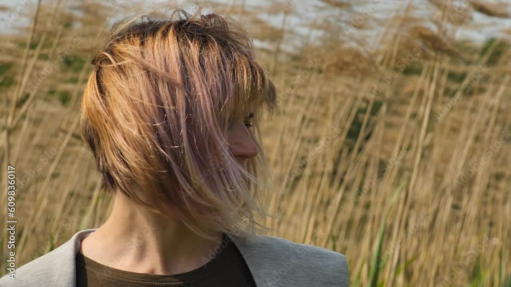 Woman in the Wind by the Lake. A young woman struggles with depression Woman in the Wind by the Lake. A young woman struggles with depression