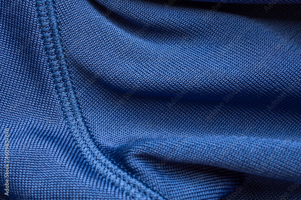 Fototapeta premium Blue sports clothing fabric football shirt jersey texture with stitches