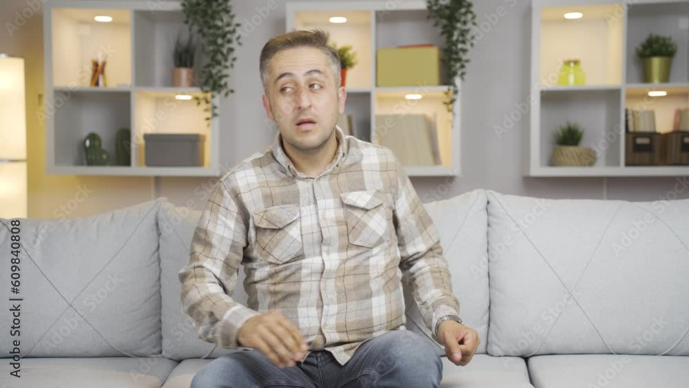 Paranoid man looking around at home. Paranoid man looking around at home.