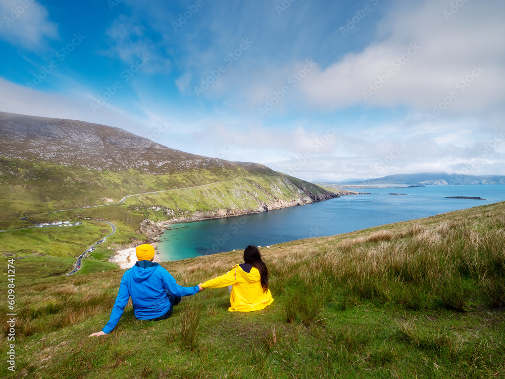 Father and daughter on a trip to nature with stunning view. Nature scene in the background with mountains, beach, ocean and cloudy sky. Separated after divorce family concept. Parent day theme. Father and daughter on a trip to nature with stunning view. Nature scene in the background with mountains, beach, ocean and cloudy sky. Separated after divorce family concept. Parent day theme.