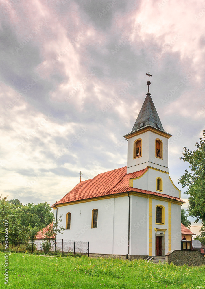 The catholic church of the Exaltation of the Holy Cross in Ustroń in the Silesian Beskids (Poland) on a cloudy summer afternoon.