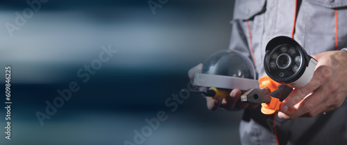 Man holding surveillance security camera.