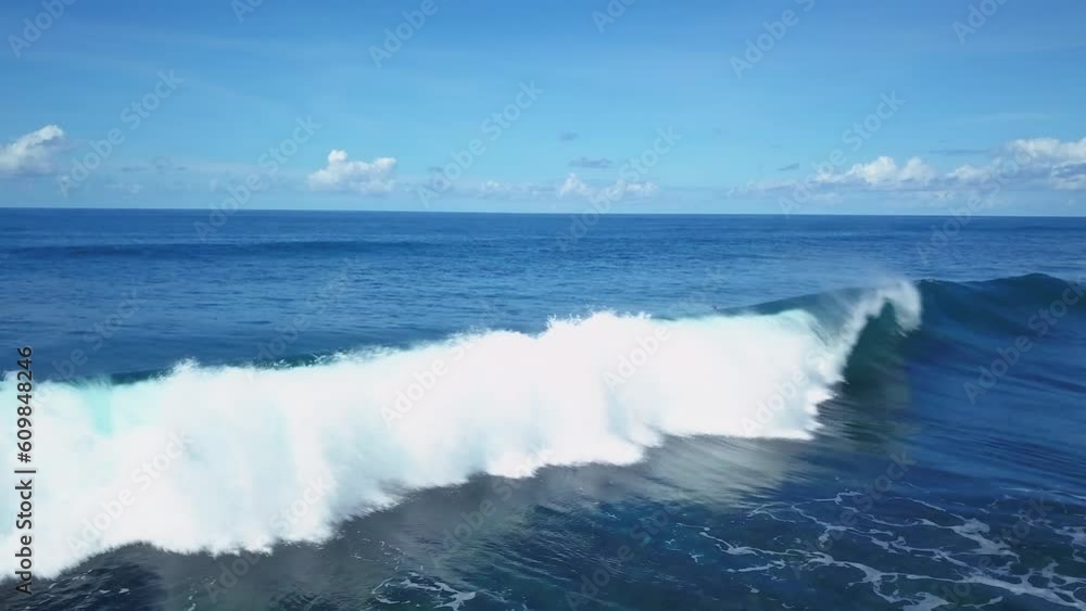Surfers paddling through crashing wave Uluwatu Bali Dreamland Padang Padang Kuta resort aerial drone cinematic Indonesia swell deep blue aqua oceans with white sand day beautiful sky still Surfers paddling through crashing wave Uluwatu Bali Dreamland Padang Padang Kuta resort aerial drone cinematic Indonesia swell deep blue aqua oceans with white sand day beautiful sky still