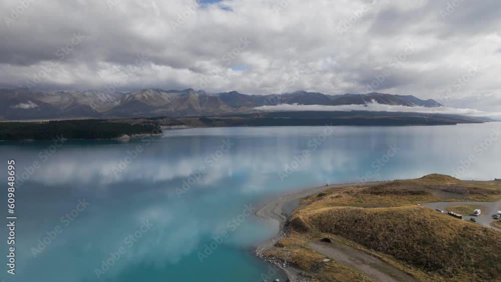 Smooth reflections of clouds and mountains at Lake Pukaki, NZ; aerial Smooth reflections of clouds and mountains at Lake Pukaki, NZ; aerial