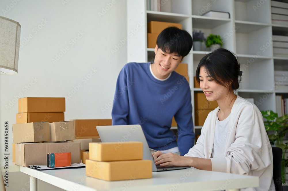A lovely couple is working in their home office, planning their product stock together. A lovely couple is working in their home office, planning their product stock together.
