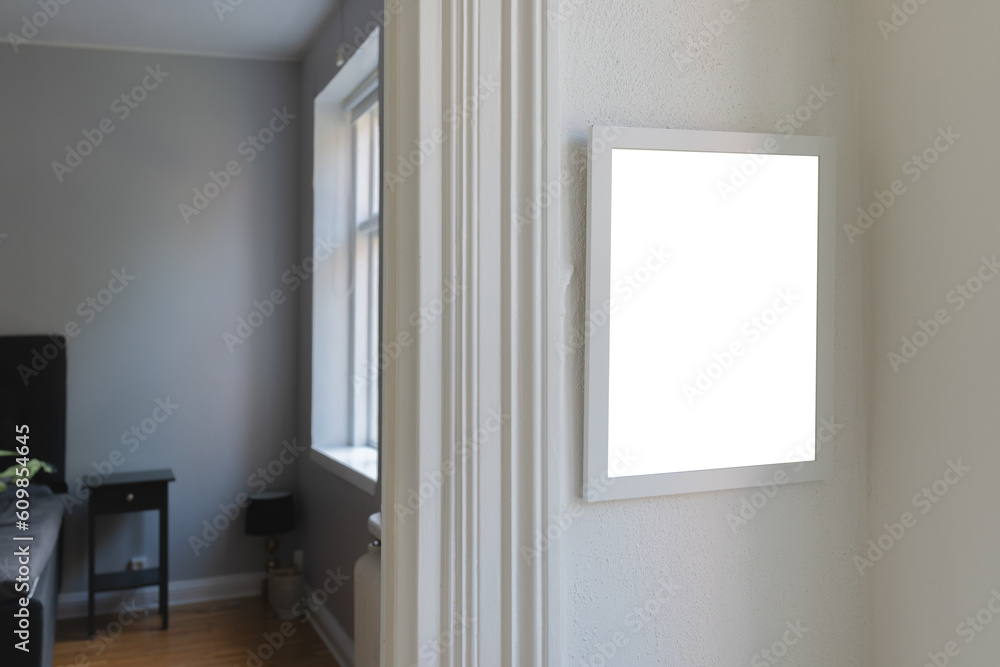 White wooden picture frame with mockup space for photography hanging on living room wall White wooden picture frame with mockup space for photography hanging on living room wall
