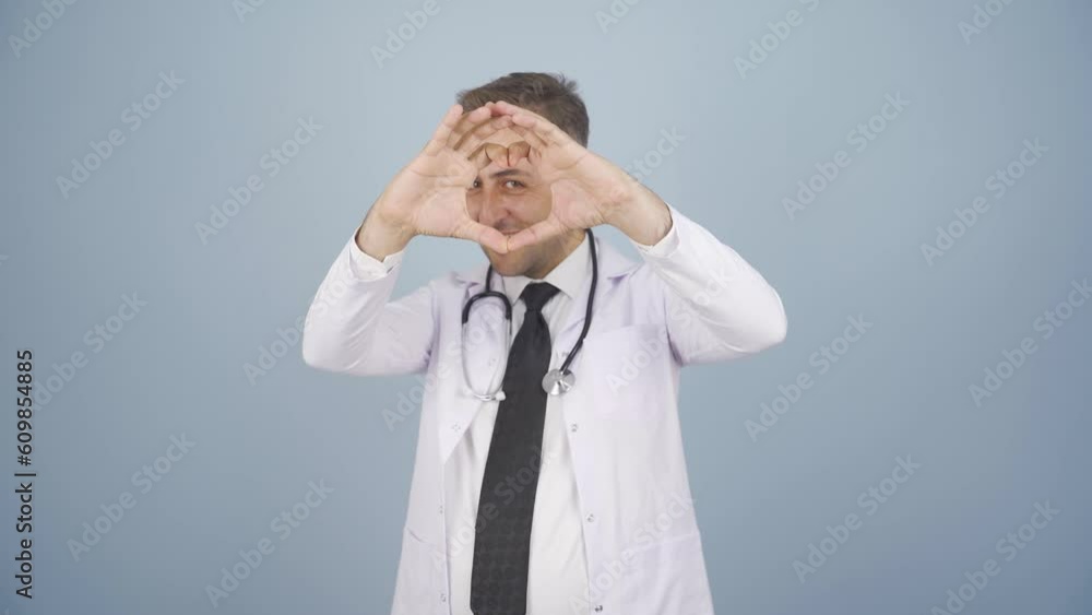 Doctor making heart looking at camera. Doctor making heart looking at camera.