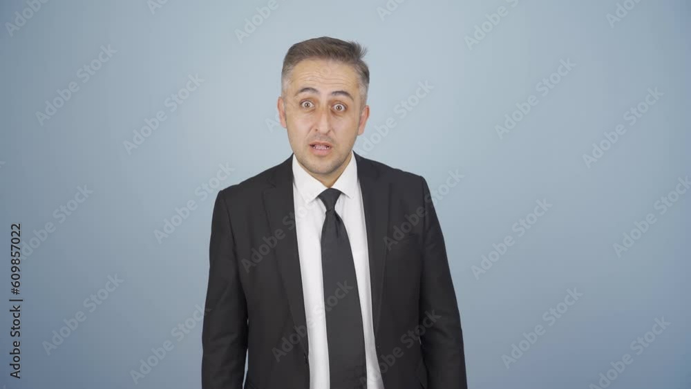 Businessman looking at camera in amazement. Businessman looking at camera in amazement.