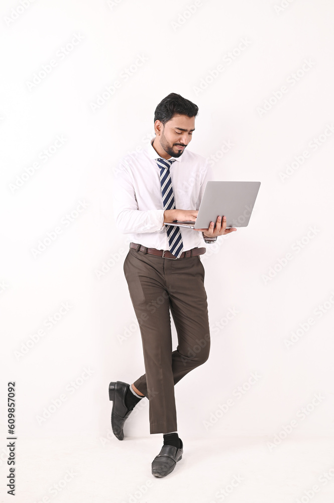 Full-length image of a young Asian businessman holding a Laptop. Full length of good looking young man carrying laptop. Full-length image of a young Asian businessman holding a Laptop. Full length of good looking young man carrying laptop.