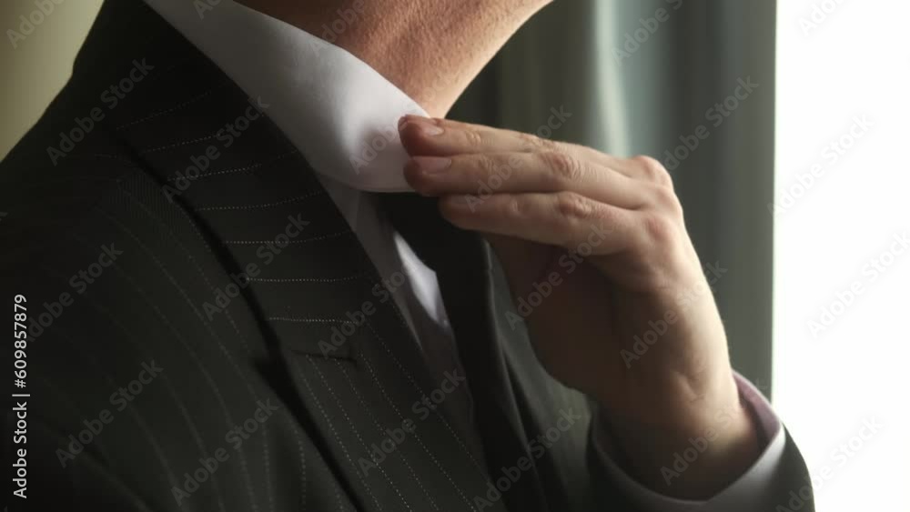 Business man put suit on during morning routine at home, preparing to go to work
