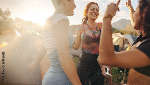 Fun in the sunset: Friends dancing at the summer festival photo