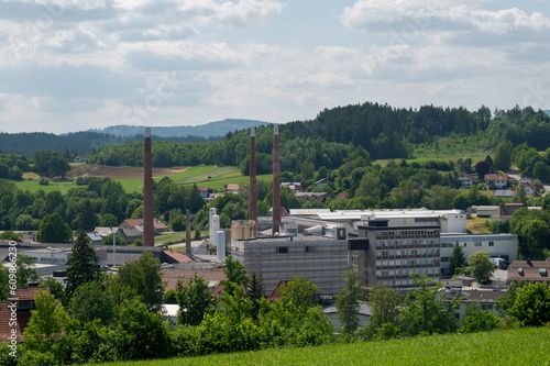 The factory buildings of the Zwiesel Kristallglas AG in the town Zwiesel in Bavaria, Germany on sunny day with clouds