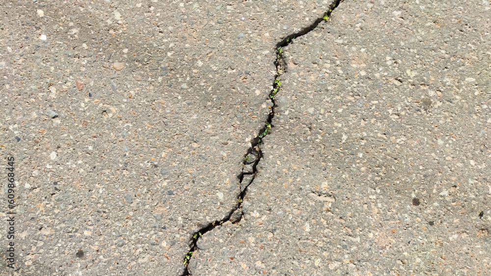 Abstract grey background and asphalt texture with a black curved crack ...