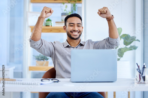 Businessman, laptop and celebrate success or win at desk with fist for bonus deal. Excited Asian man or entrepreneur with tech for profit, competition or online achievement and loan notification