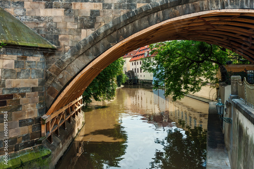 Narrow canal under the Charles Bridge in Prague.