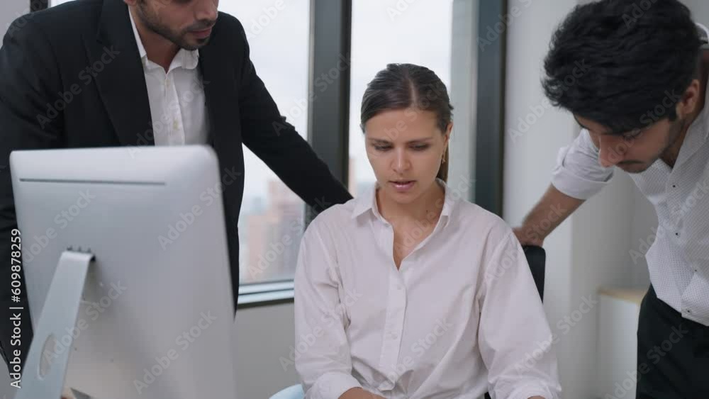 Happy young confident businesswoman sitting at the office table with group of colleagues Happy young confident businesswoman sitting at the office table with group of colleagues
