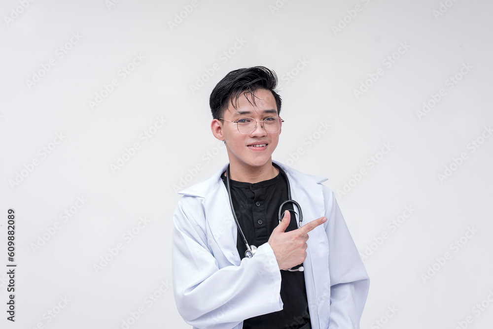 Portrait of a young and professional doctor, medical student, intern, posing with his hands pointing at the side. Isolated on a white background. Portrait of a young and professional doctor, medical student, intern, posing with his hands pointing at the side. Isolated on a white background.