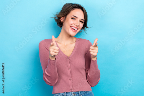 Photo of shiny confident lady wear pink cardigan smiling pointing two fingers you isolated blue color background