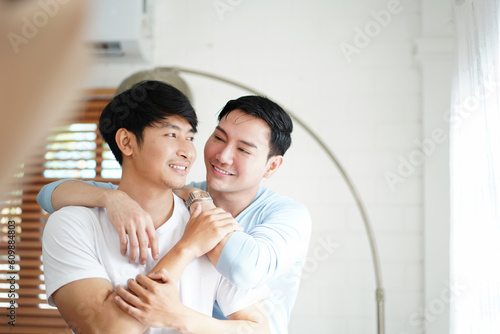 happy gay couple in love spending time together tender moments in living room. Homosexual love relationship and gender equality