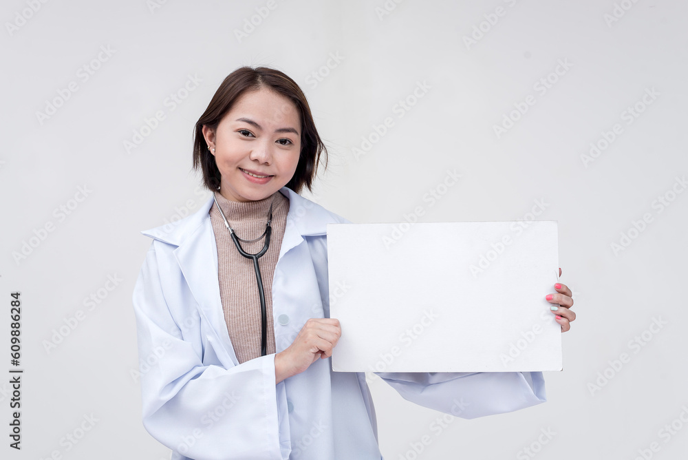 Portrait of a young and skilled doctor, medical student, intern holding and pointing at a sign board. Isolated on a white background. Portrait of a young and skilled doctor, medical student, intern holding and pointing at a sign board. Isolated on a white background.