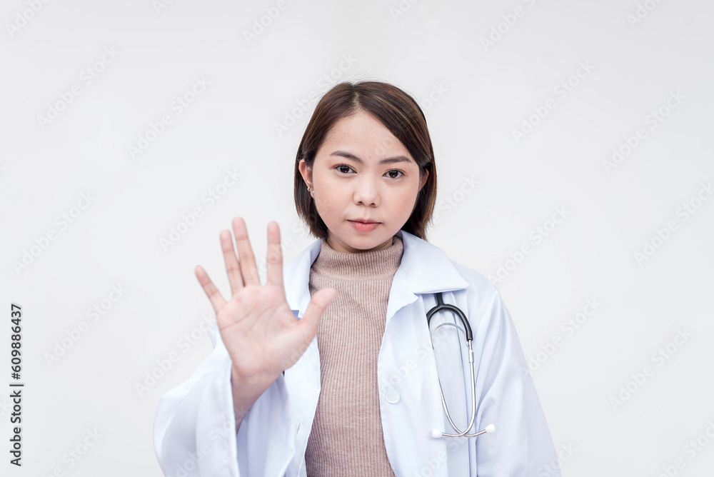 Portrait of a young and skilled doctor, medical student, intern posing with palms faced on the camera, telling someone to stop. Isolated on a white background. Portrait of a young and skilled doctor, medical student, intern posing with palms faced on the camera, telling someone to stop. Isolated on a white background.