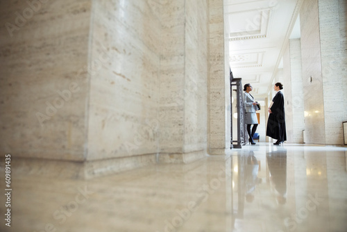 Lawyer and judge talking in hallway of courthouse © KOTO