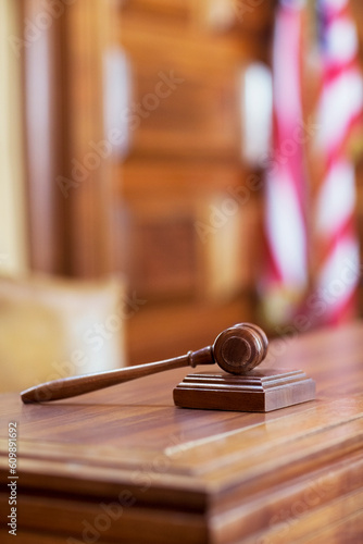 Gavel laying on judge‚Äôs bench in court