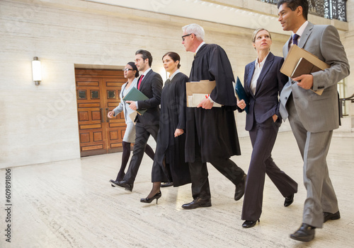 Obraz na plátně Judges and lawyers walking through courthouse together
